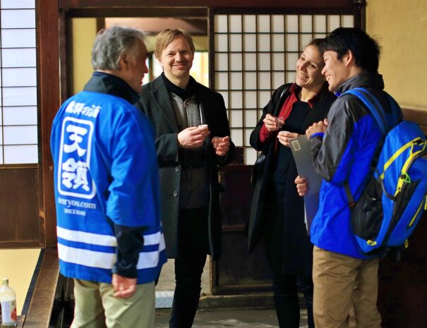 European guests enjoying sake tasting at the local sake brewery in Hida