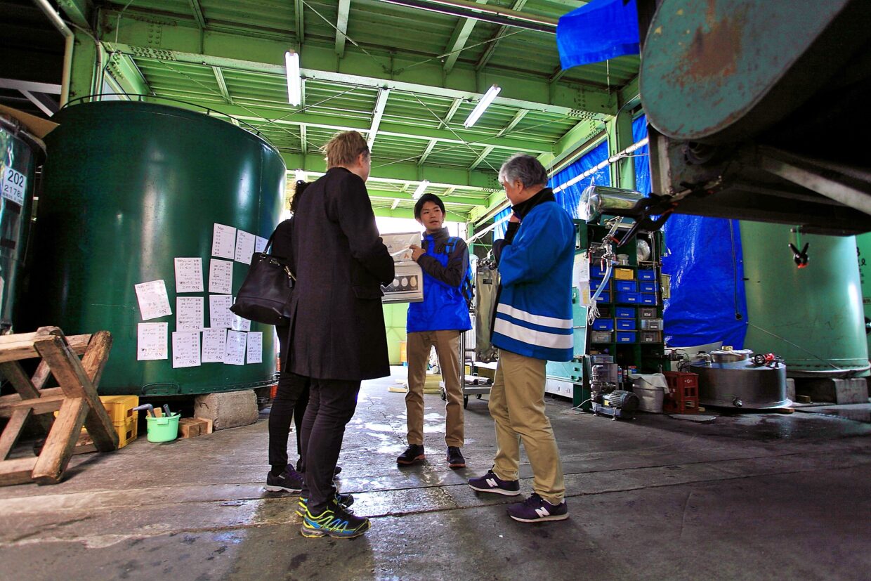 A sake brewery tour guide tell guests how to make sake in Hida Takayama
