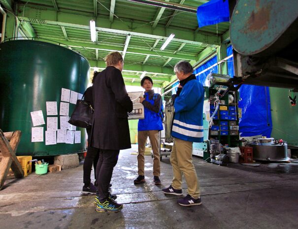 A sake brewery tour guide tell guests how to make sake in Hida Takayama
