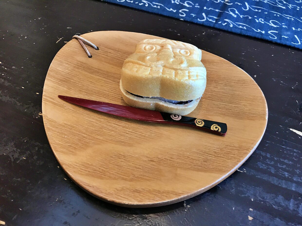 A traditional Japanese sweet placed on the wooden plate