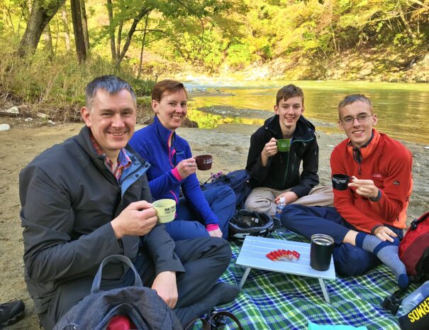 English family enjoying tea time by the riverside