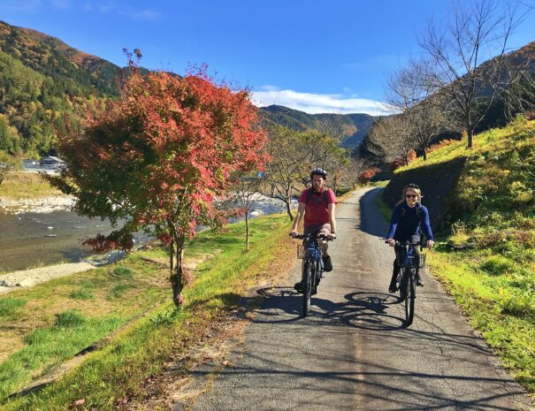 European guests enjoying cycling in the field of countryside in Japan