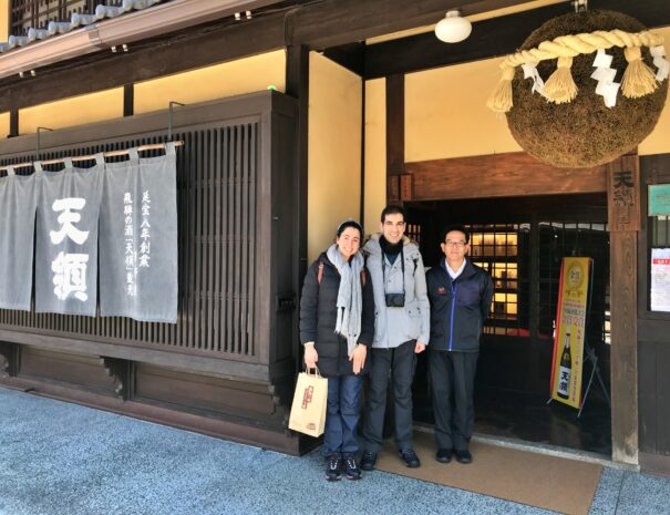 Overseas travelers in front of Japanese traditional sake brewery